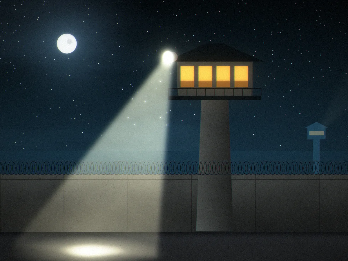 Convicted concept art: a concrete guard tower with lit windows rising above a perimeter wall topped with razor wire, its searchlight beam sweeping down into the yard under a full moon